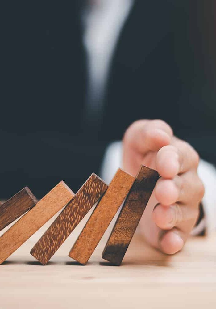 protection and risk management, Financial risk management ,Business Investment Feasibility Assessment, protection of business interests, Human hands blocking wooden sticks